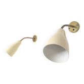 Pair of brass and cream-colored metal wall lights from the 1950s