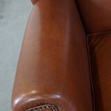 Cognac-colored leather wingback chair in English style