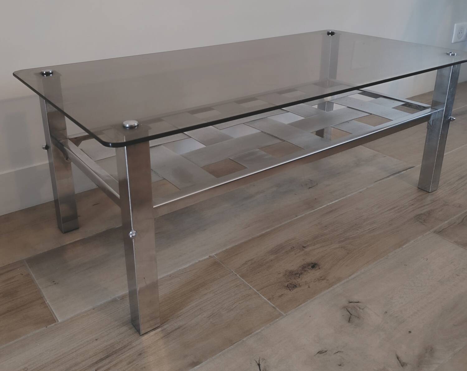 Vintage smoked glass coffee table with chrome legs.