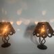 Pair of black wrought iron lanterns with heart patterns, romantic style.