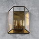 Wall sconce in brass and glass