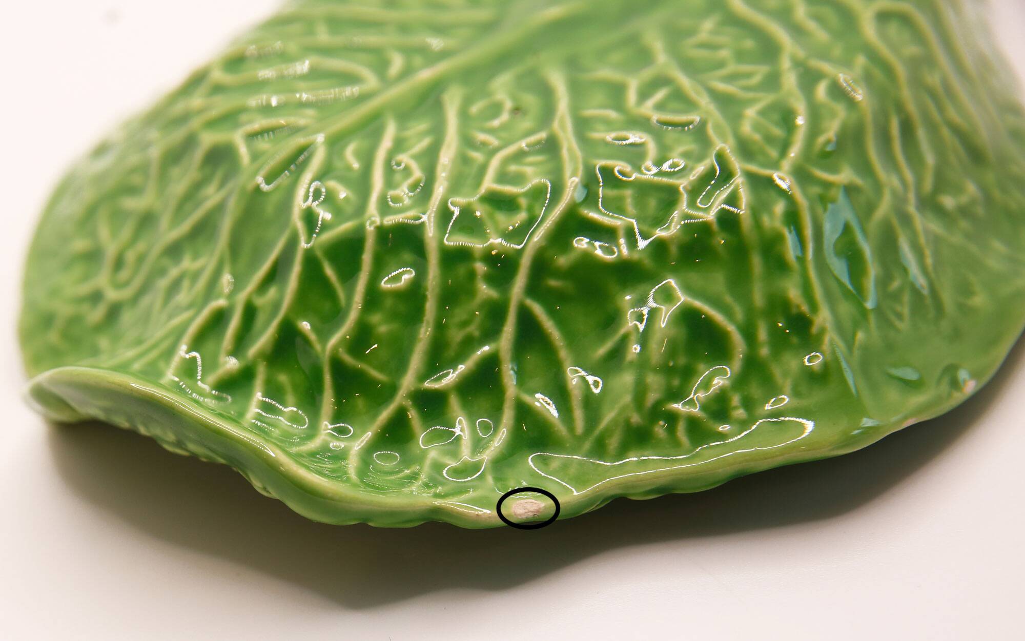 Trompe l'oeil cup bright green cabbage leaf in slip