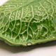Trompe l'oeil cup bright green cabbage leaf in slip
