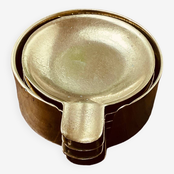 Set of four stackable brass ashtrays