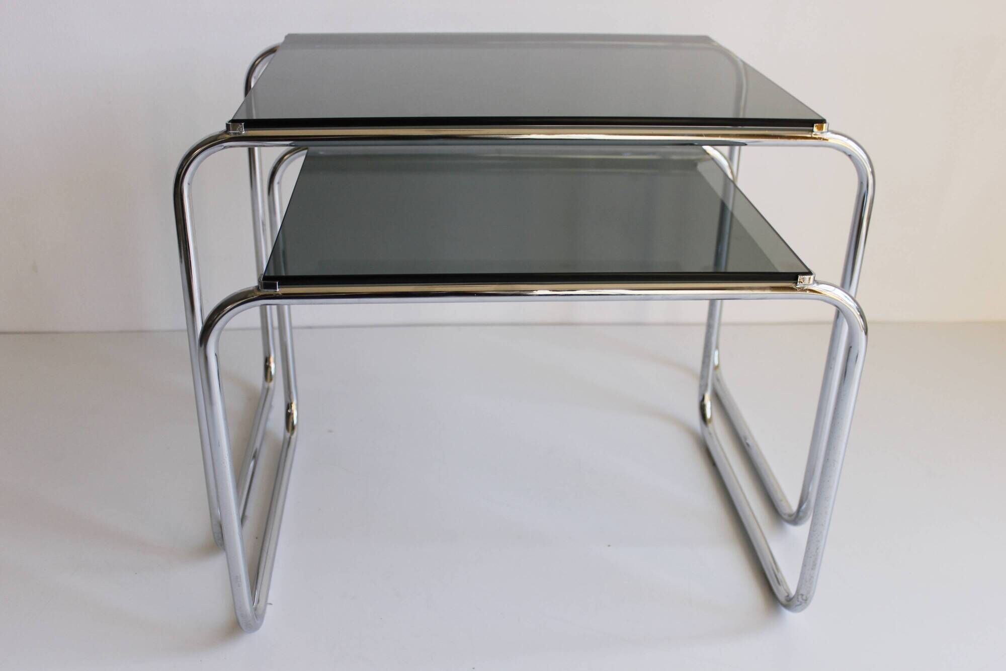 Tubular steel and smoked glass side tables, set of 2