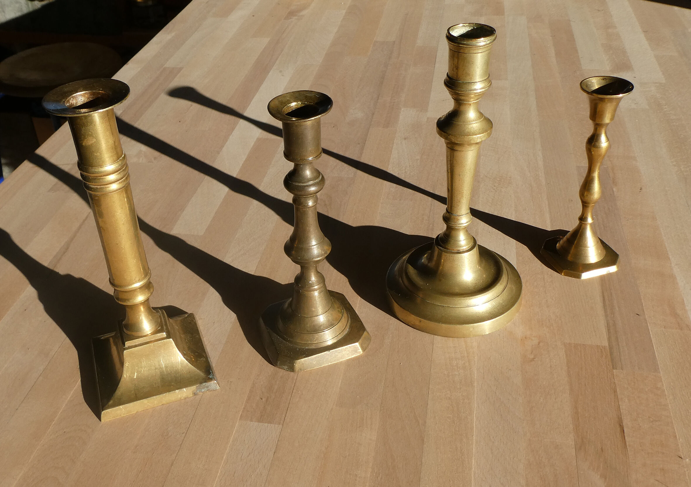 Set of 4 old candle holders in golden brass