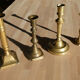 Set of 4 old candle holders in golden brass
