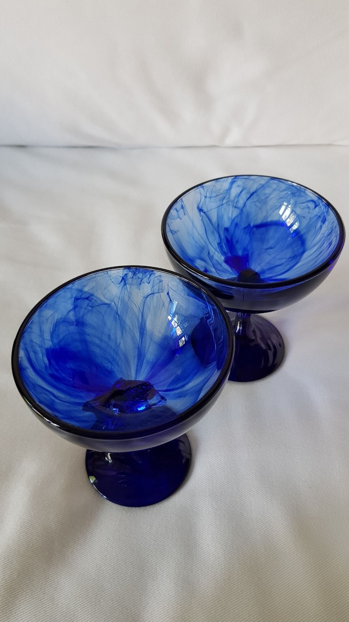 Set of 2 dolphin dessert cups in blue glass.