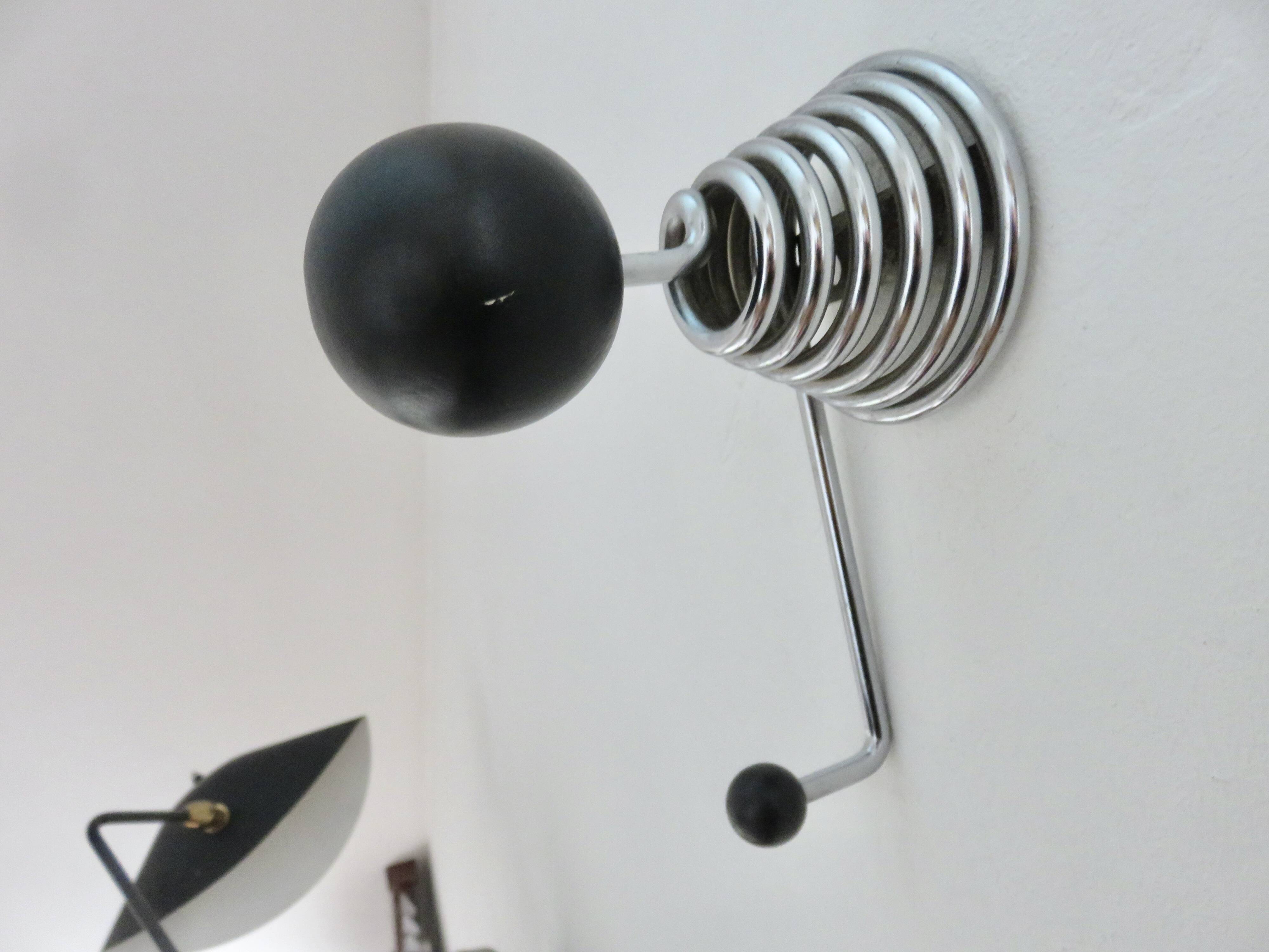 "Streamline" wall coat rack in chromed metal and black lacquered wood, 1970.