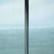Vintage floor lamp in milky glass and chrome, minimalist uplight lighting.