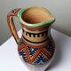 Small Moroccan jug in glazed terracotta, signed, Berber decoration, 20th century.