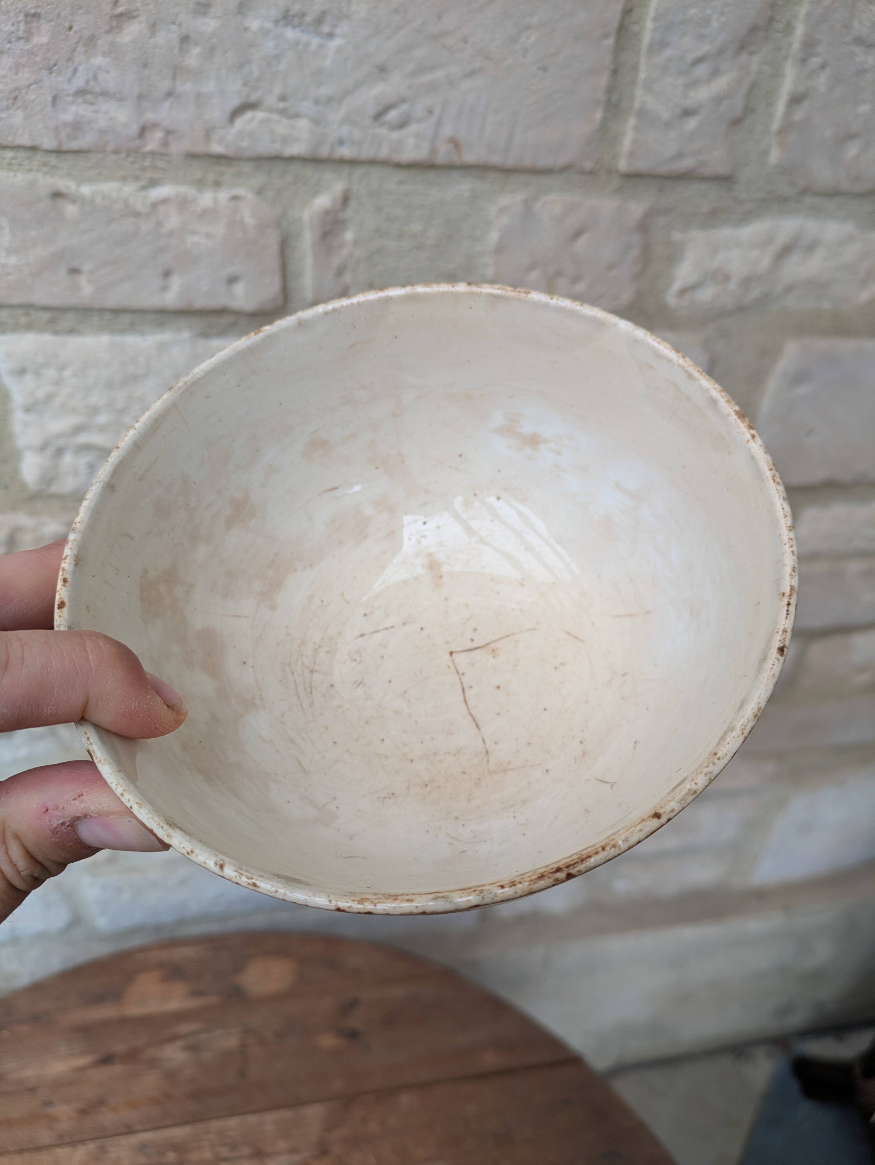 Old opaque porcelain bowl from Gien with a floral decoration.