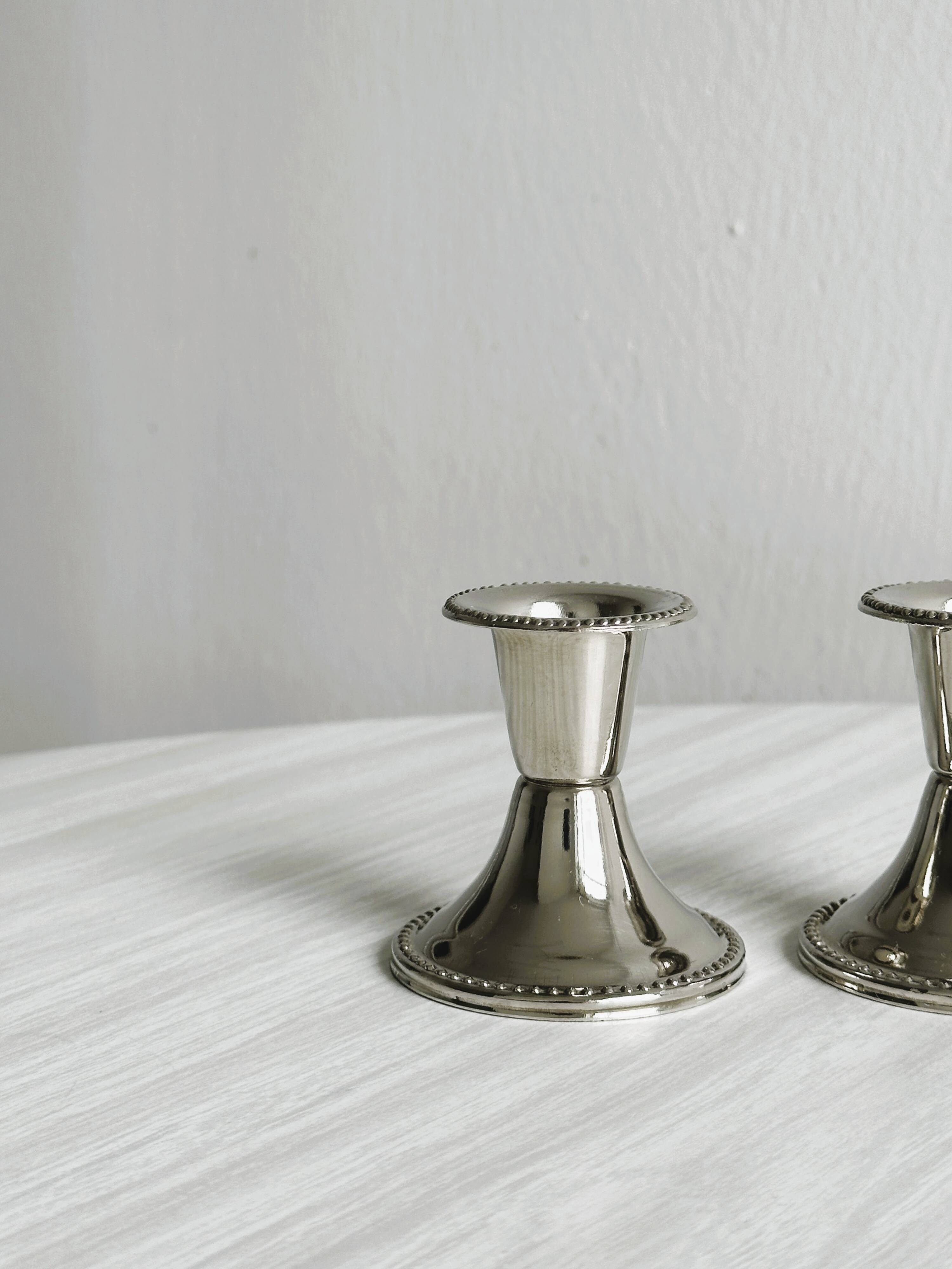Pair of small light metal candlesticks