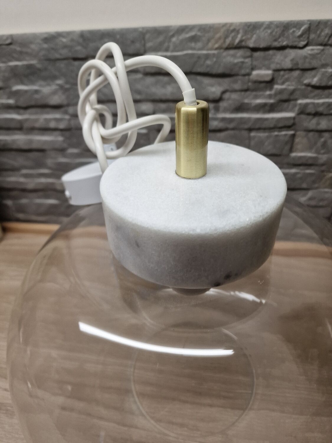 Glass globe pendant light with marble