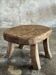 Small stool, oval solid teak side table with curved legs in wabi-sabi style.