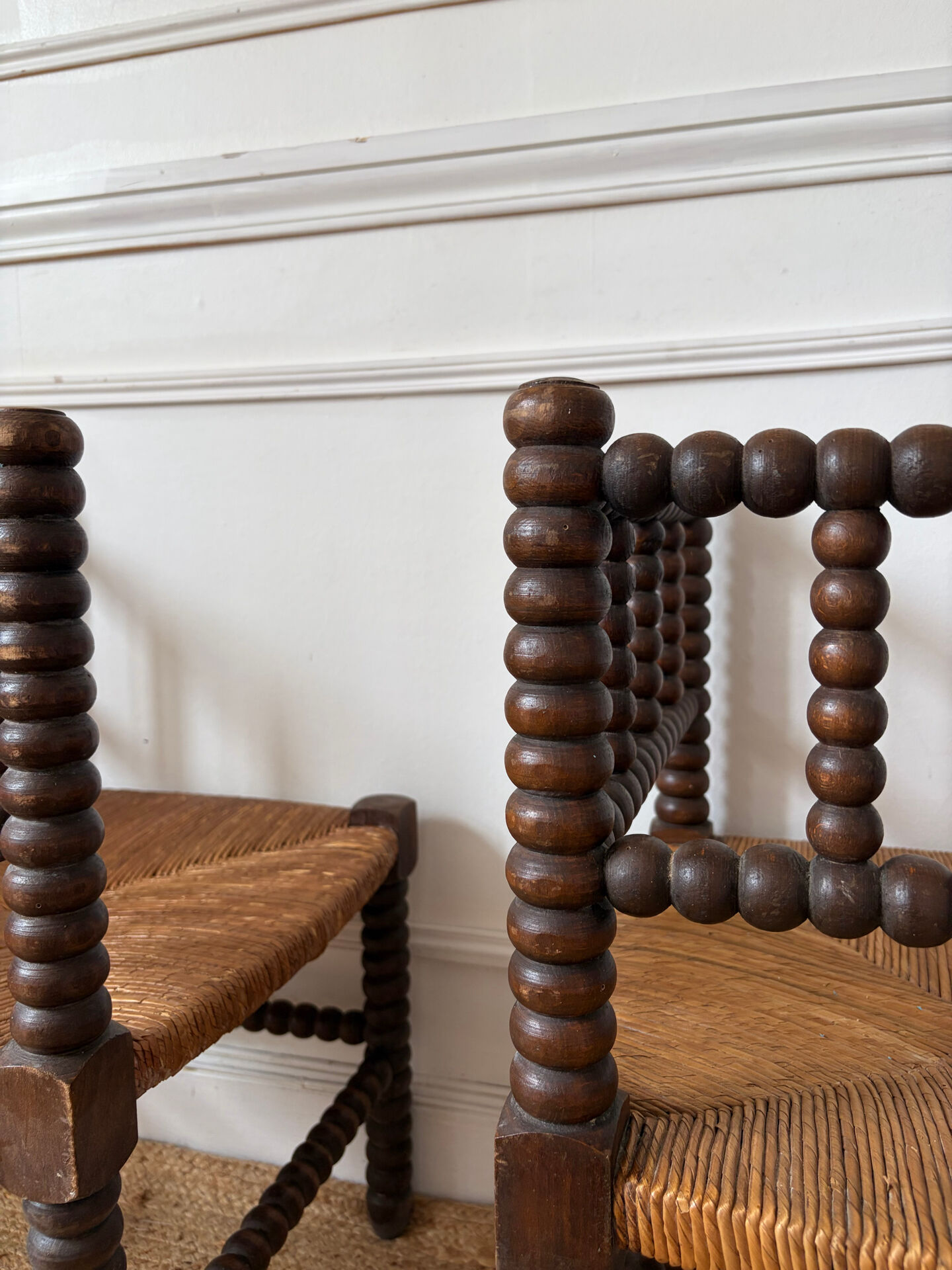 Pair of rush-seated chairs by the fireside "bobbin"