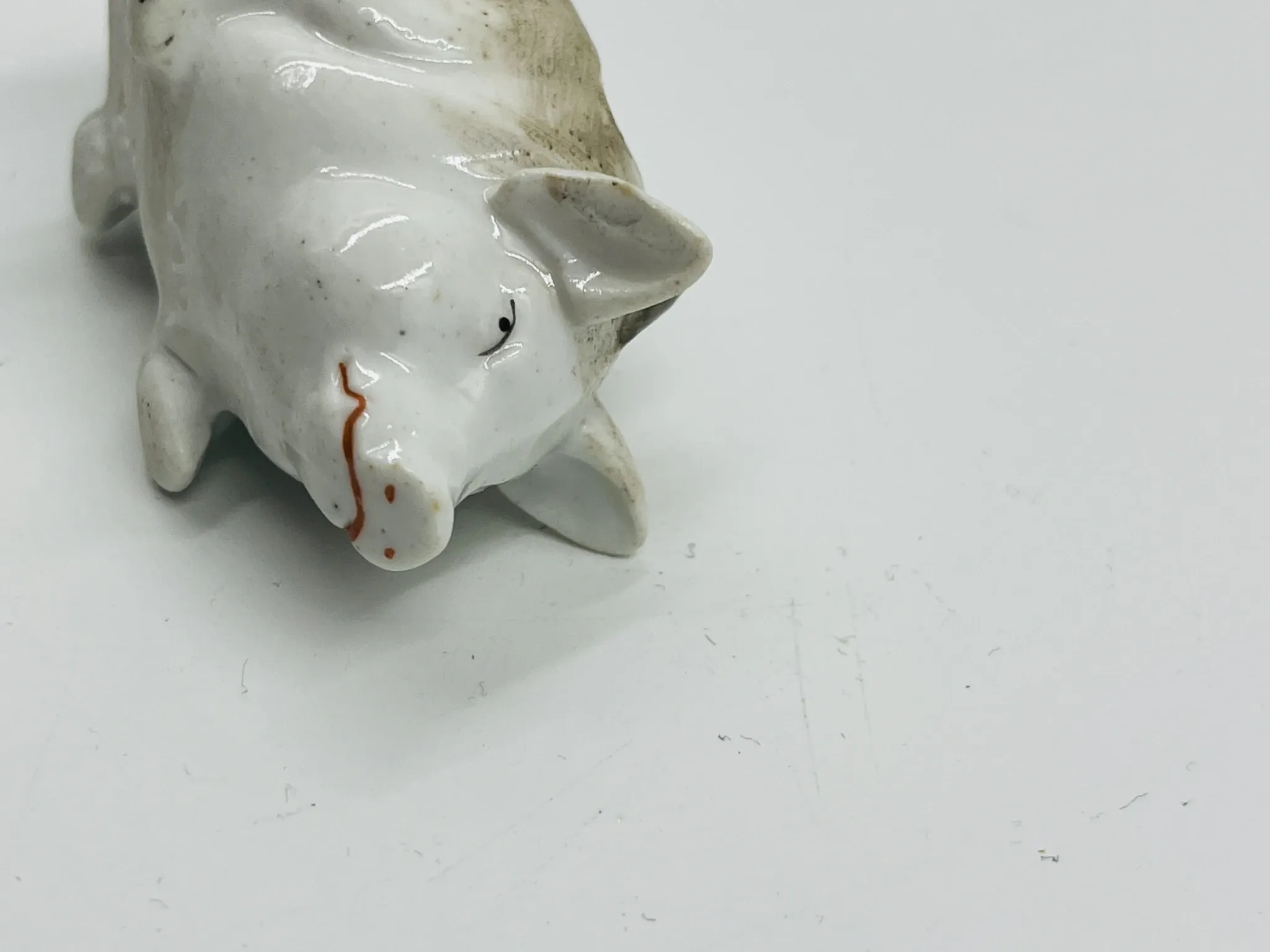 Vintage mustard pot in porcelain shaped like a pig.