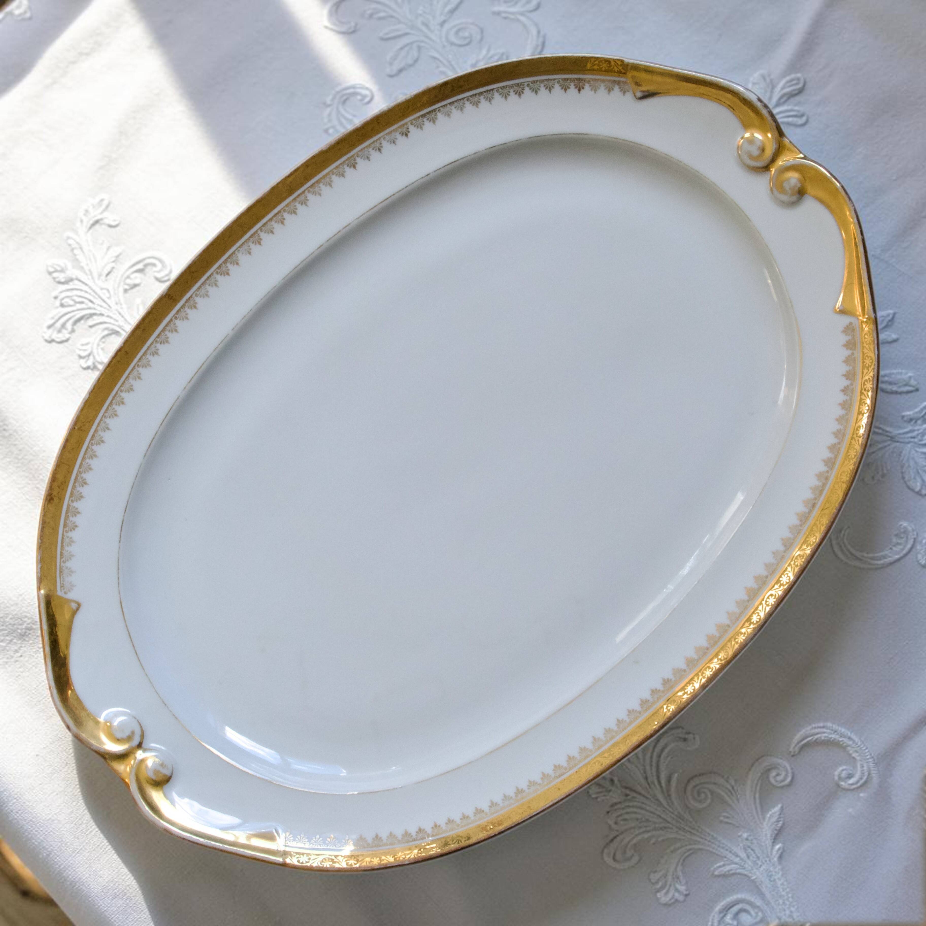 Very large oval dish with gold trim in Limoges porcelain by Peconnet.