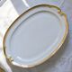 Very large oval dish with gold trim in Limoges porcelain by Peconnet.