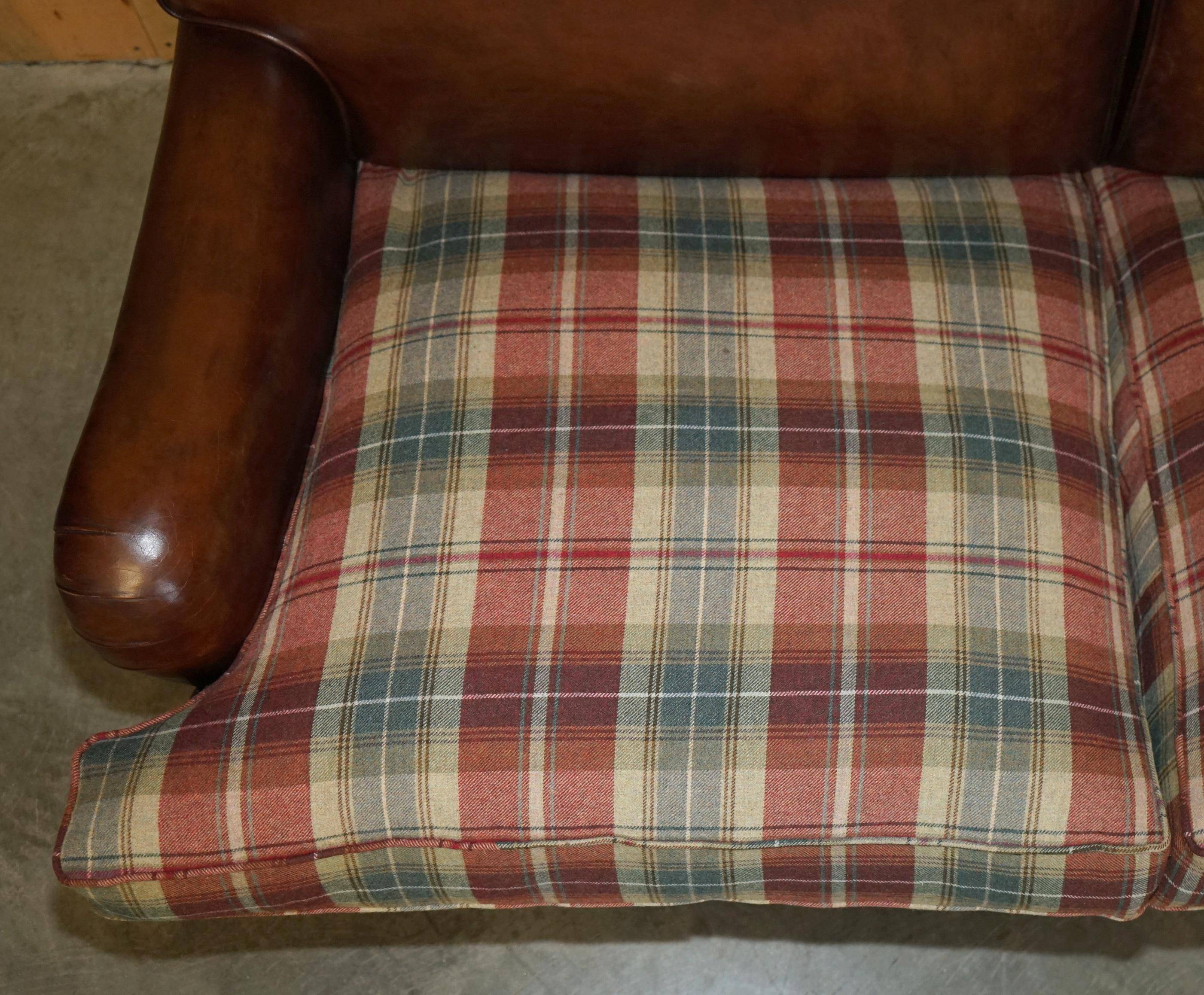 George Smith Signature Scroll leather canapé with tartan Scottish wool cushions.