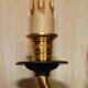 Pair of L'Originale wall sconces plated with 24-carat gold featuring four bronze candles.