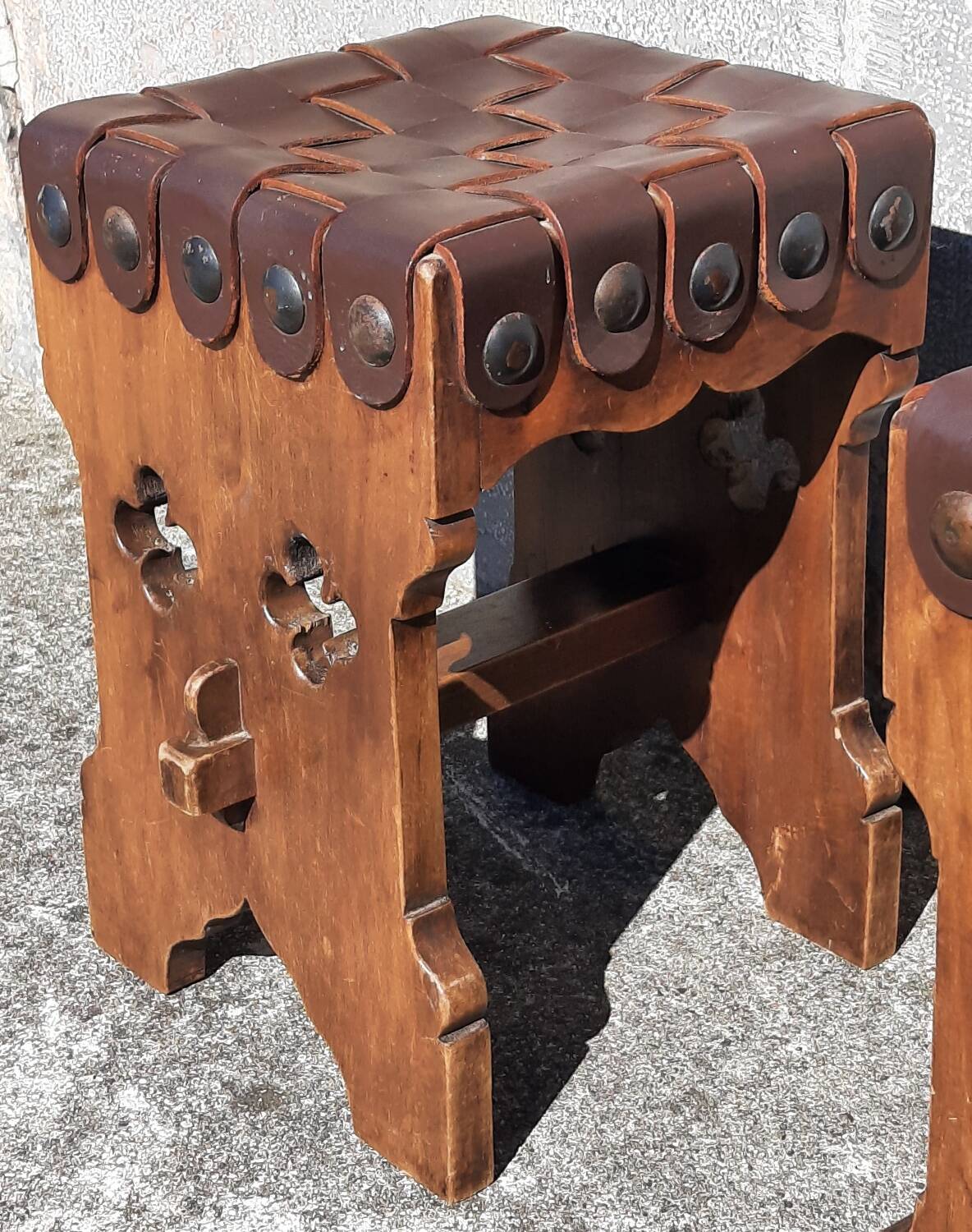 Pair of brutalist stools, leather seat.