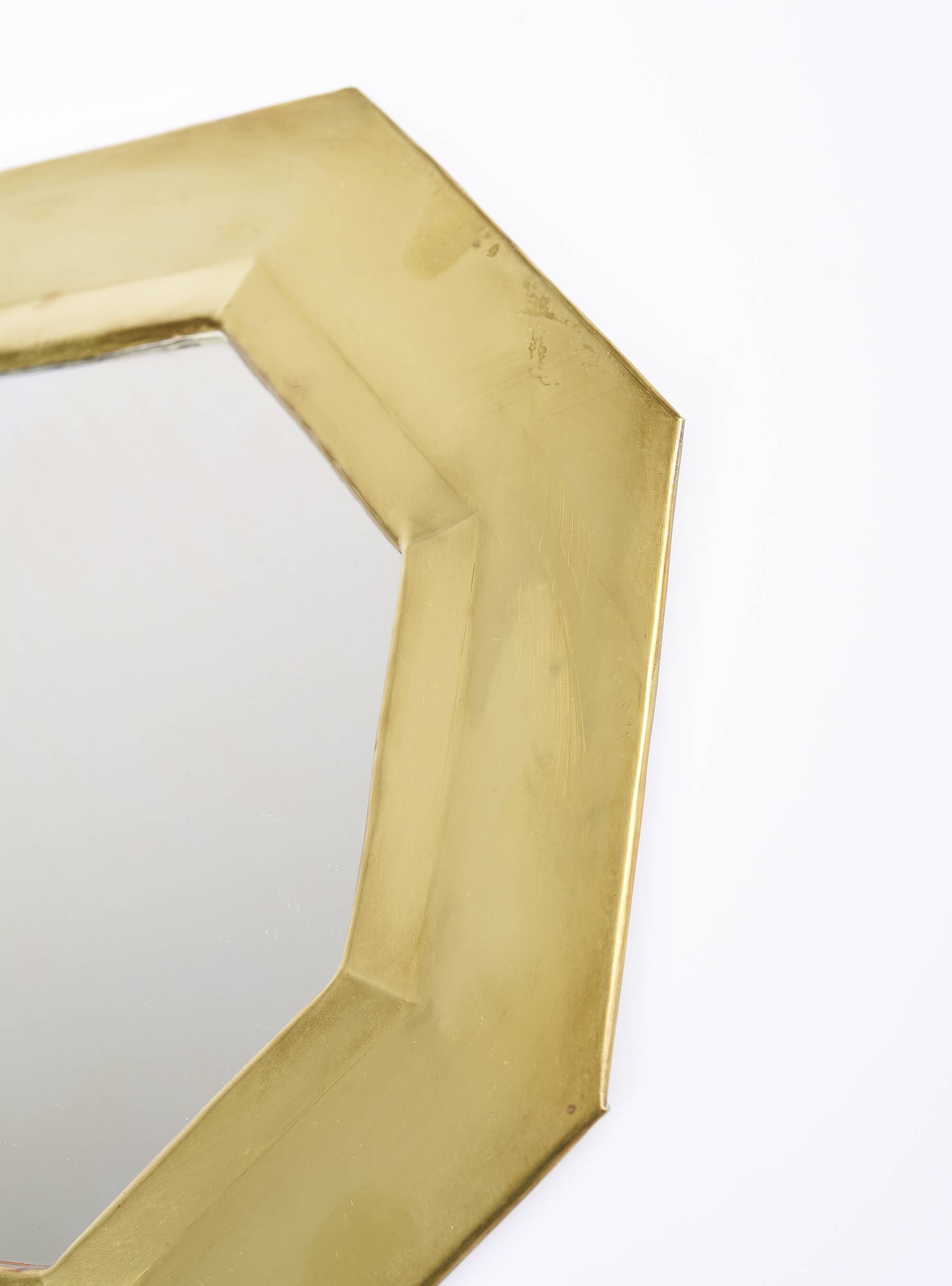 Old golden octagonal mirror, in brass