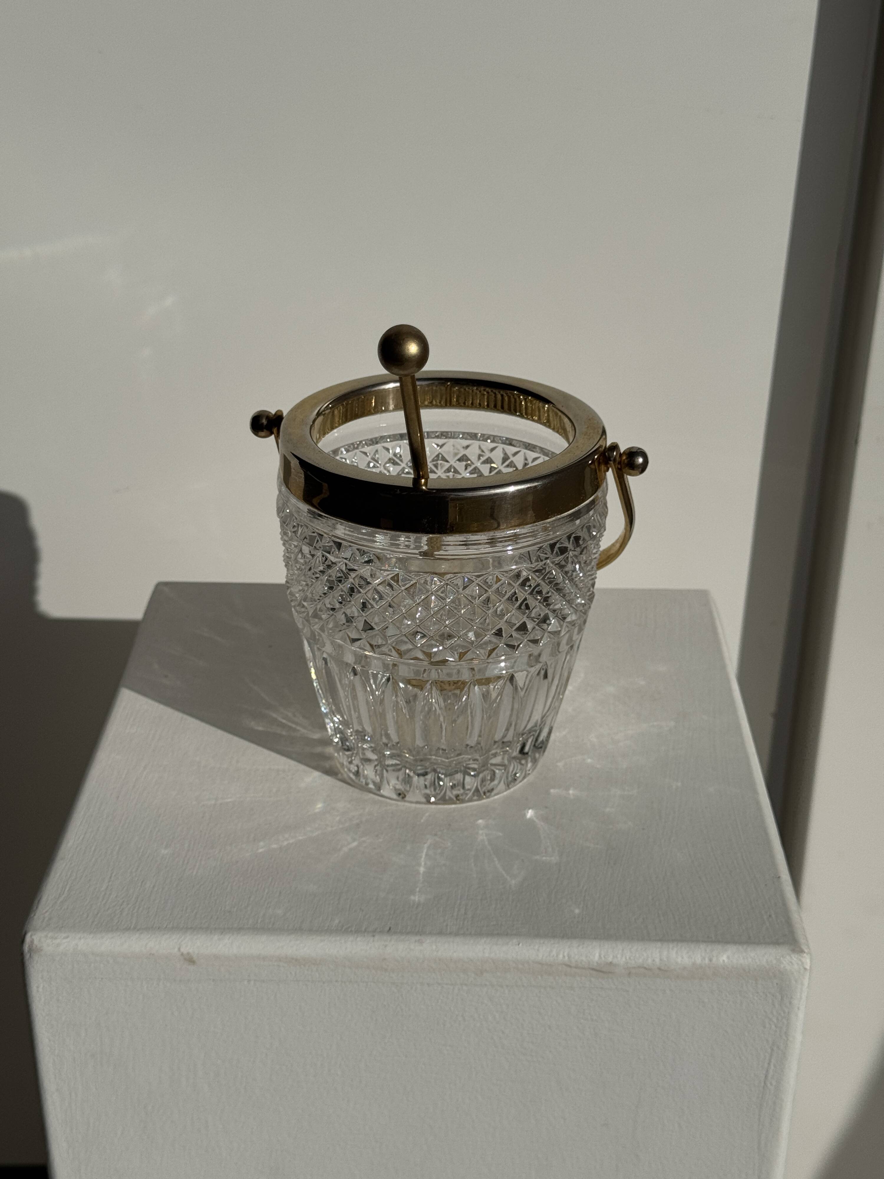 Small golden glass ice bucket with diamond point design and its scoop.