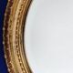 Miroir mural ovale biseauté vintage avec cadre doré vieilli