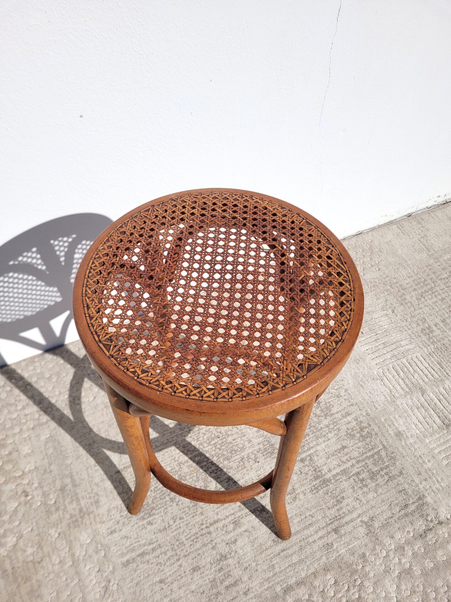 Old low caned bistro stool