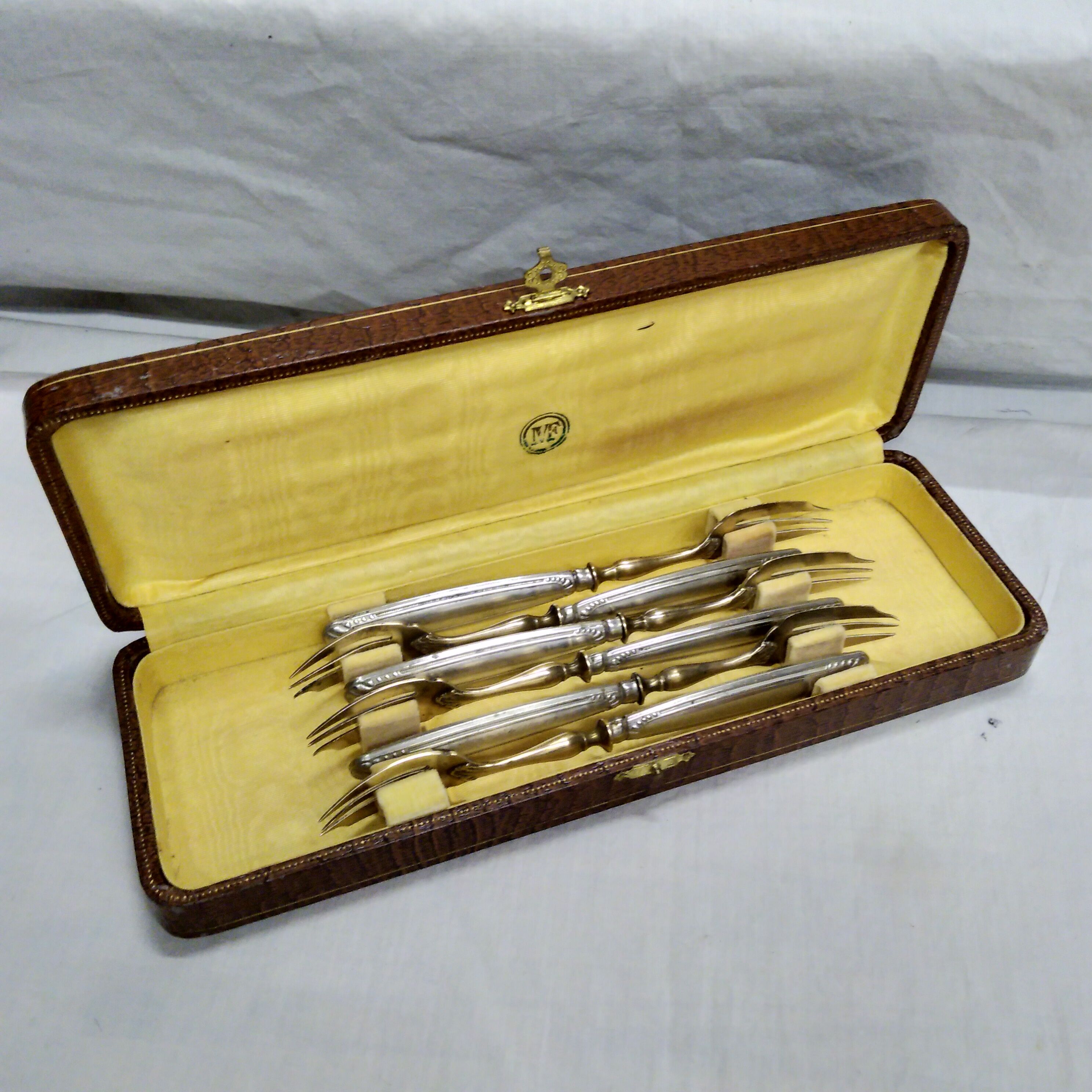 Silver and gold cake fork service