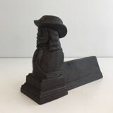 Pair of cast iron andirons in the likeness of a musketeer