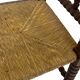 Vintage 'bobbin' bench with a rush seat, 1920s design with armrests.