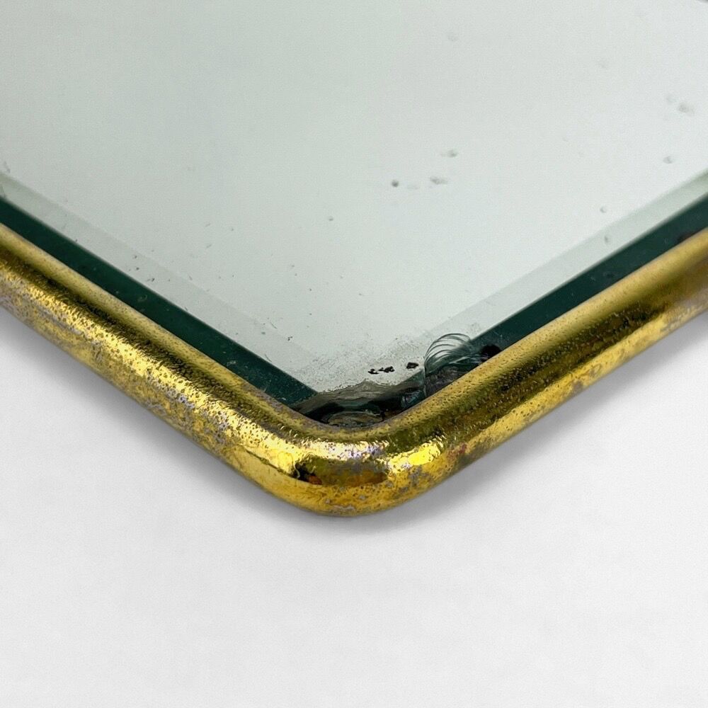 Old barber mirror in brass and beveled glass