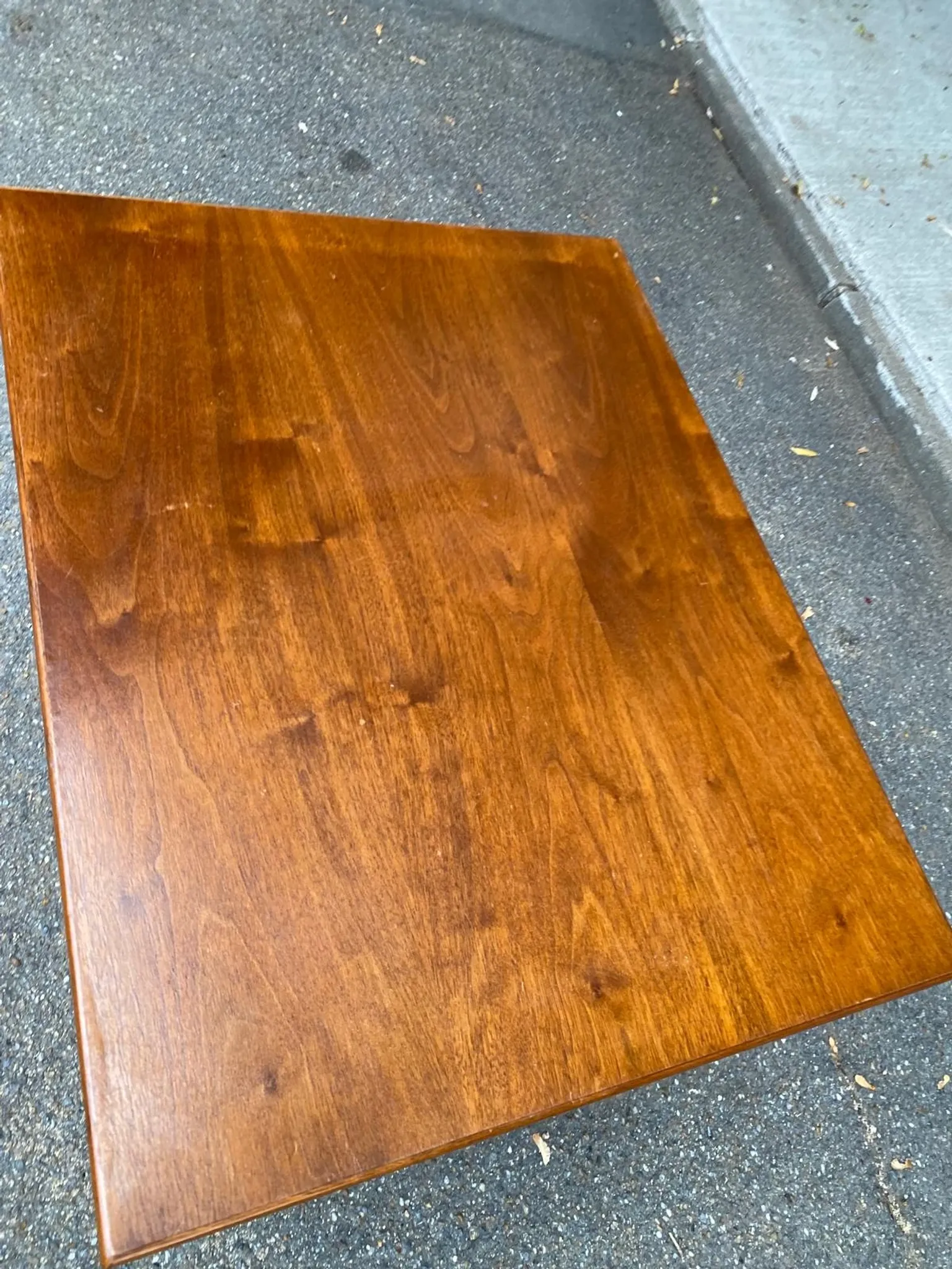 Small Scandinavian-style computer desk on wheels made of wood.