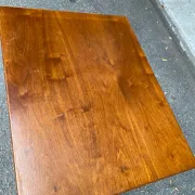 Small Scandinavian-style computer desk on wheels made of wood.