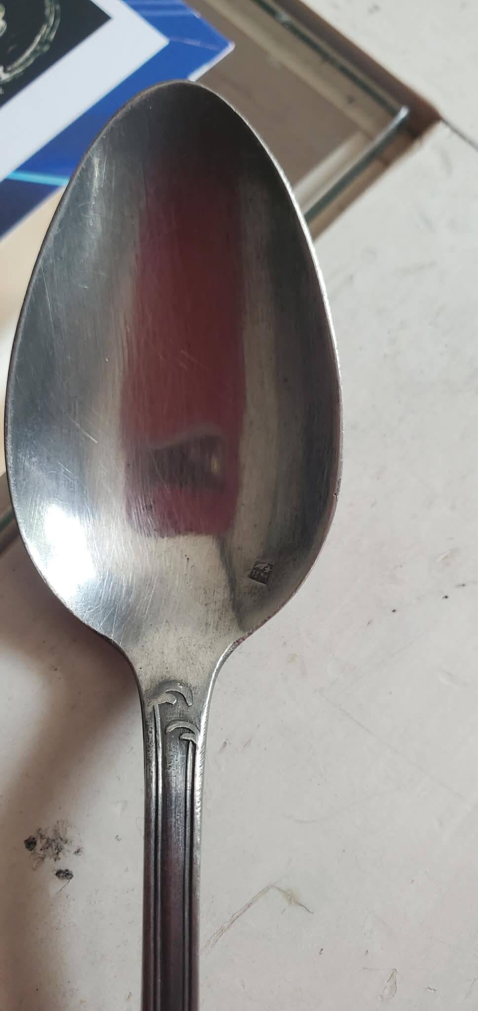 Many silver-plated metal teaspoons.