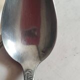 Many silver-plated metal teaspoons.