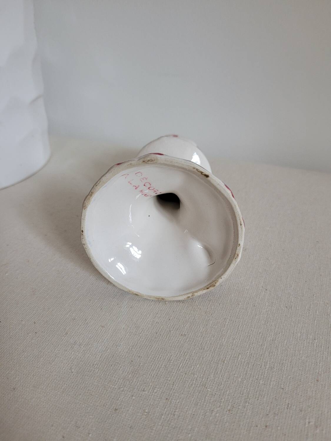 Ceramic candlestick with red and blue decoration.