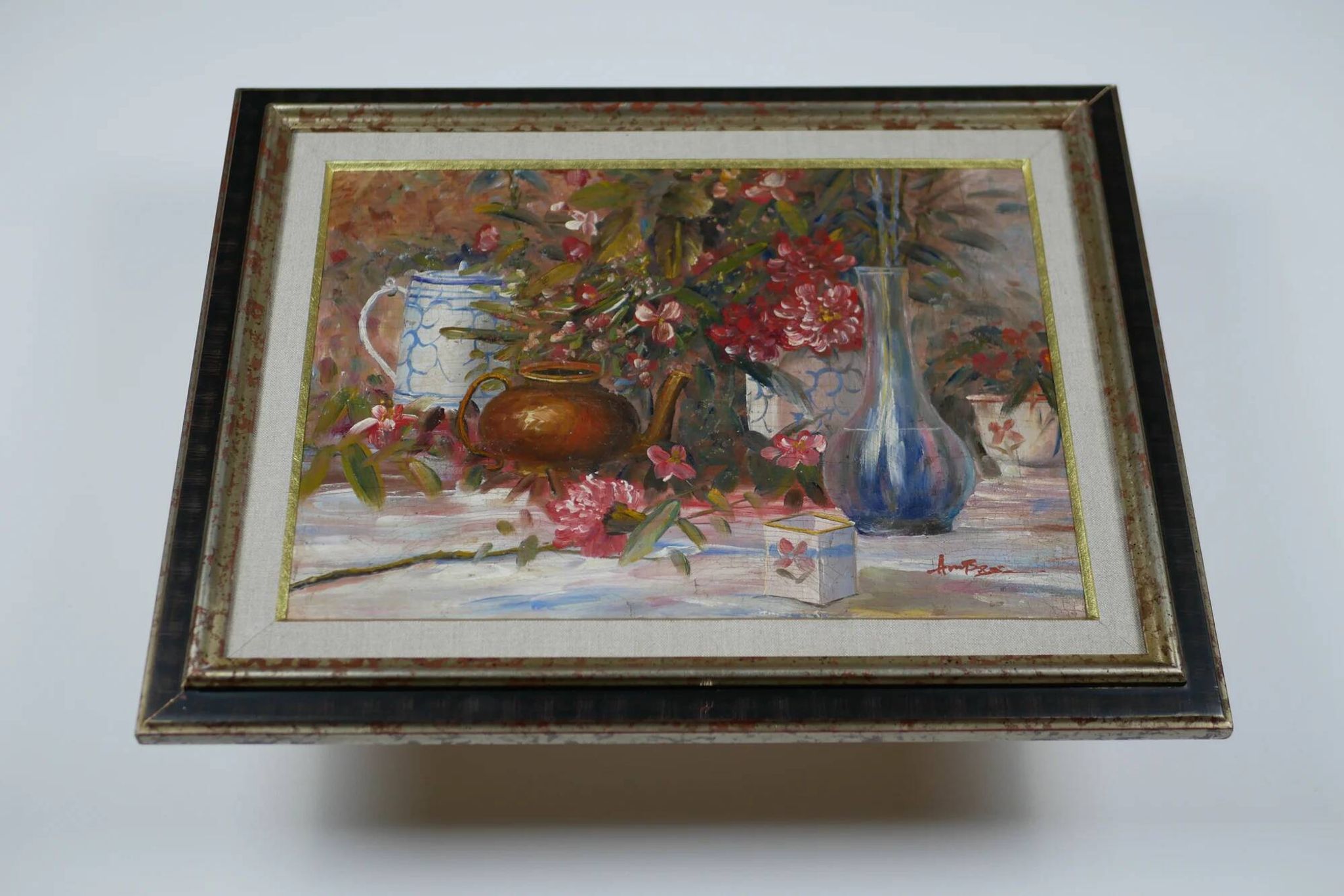 Still life with pink flowers and blue pots.