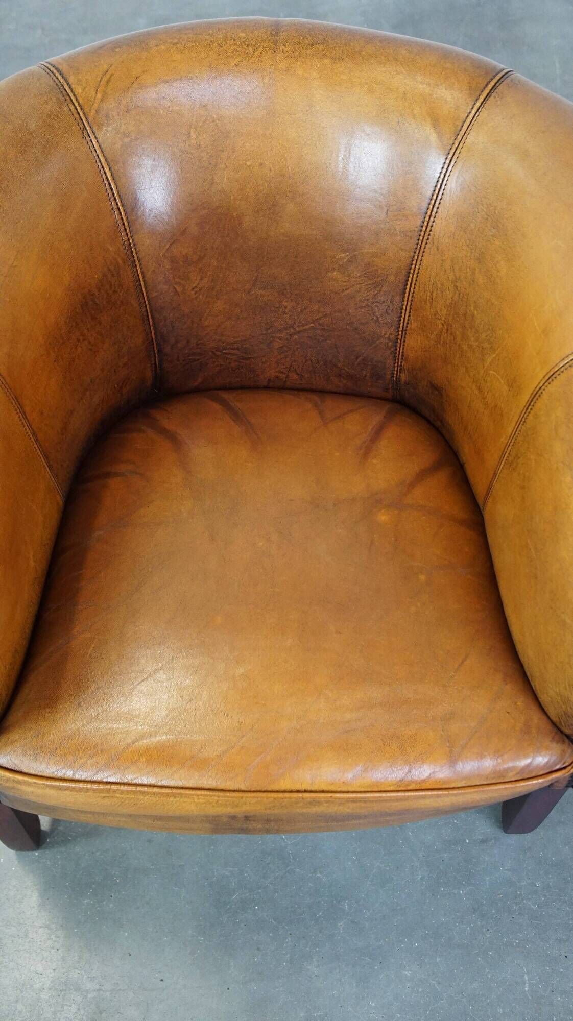 Fauteuil club en peau de mouton subtile avec finition cloutée décorative