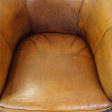 Subtle sheepskin club chair finished with decorative studs