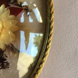 Old medallion frame of dried flowers of oval shape. To hang with velvet stripe.