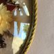 Old medallion frame of dried flowers of oval shape. To hang with velvet stripe.