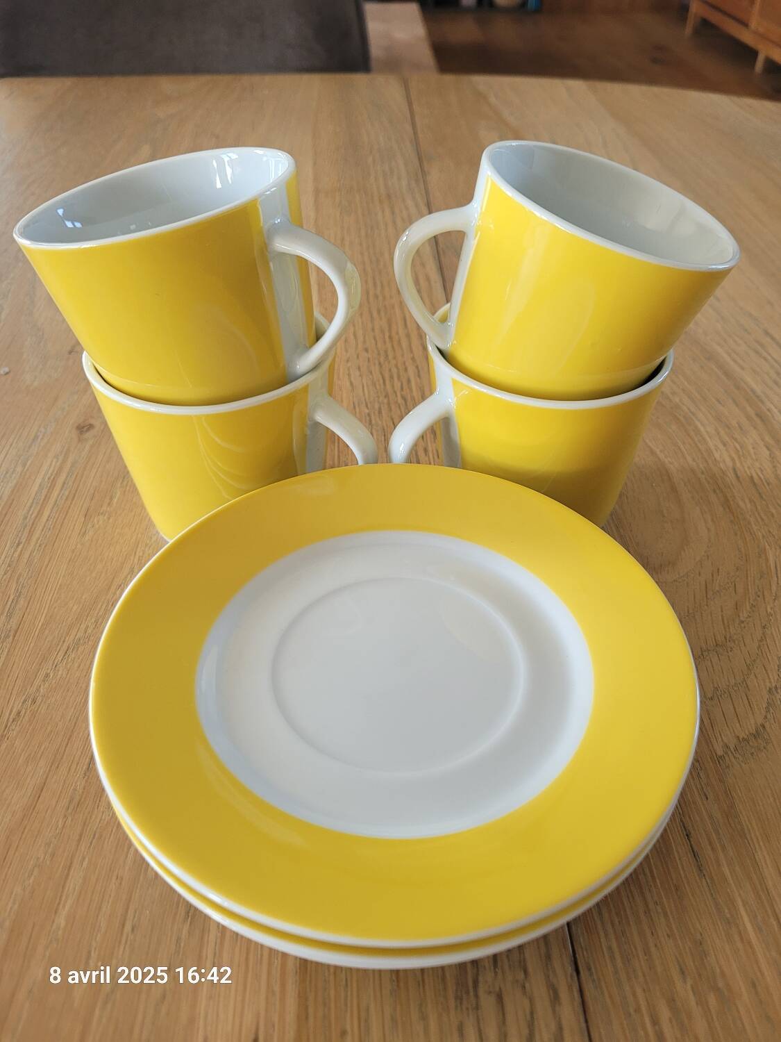 4 yellow and white cups and saucers