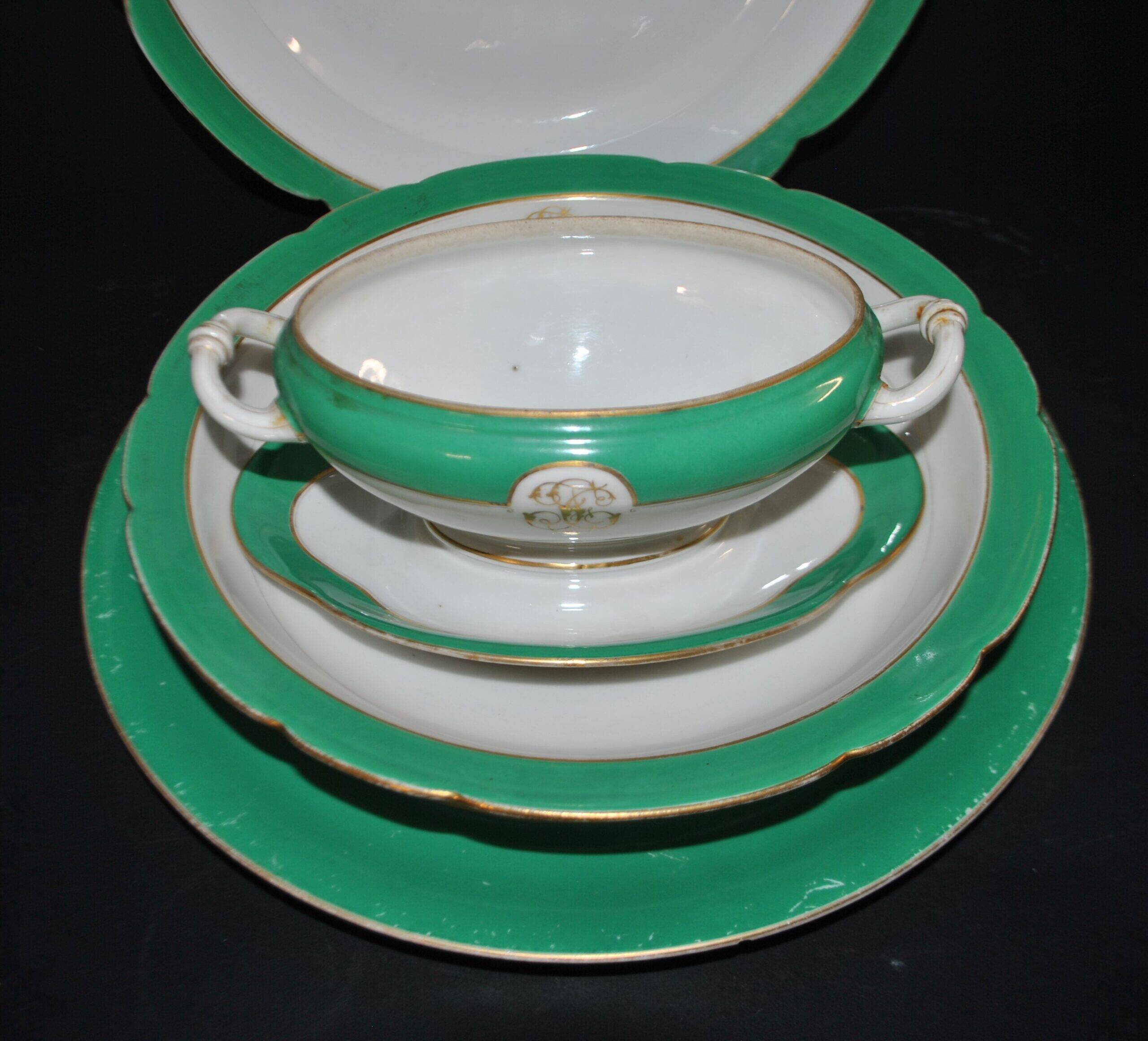 Paris porcelain set of 3 plates and a sauce boat with green border and gold monogram JC.