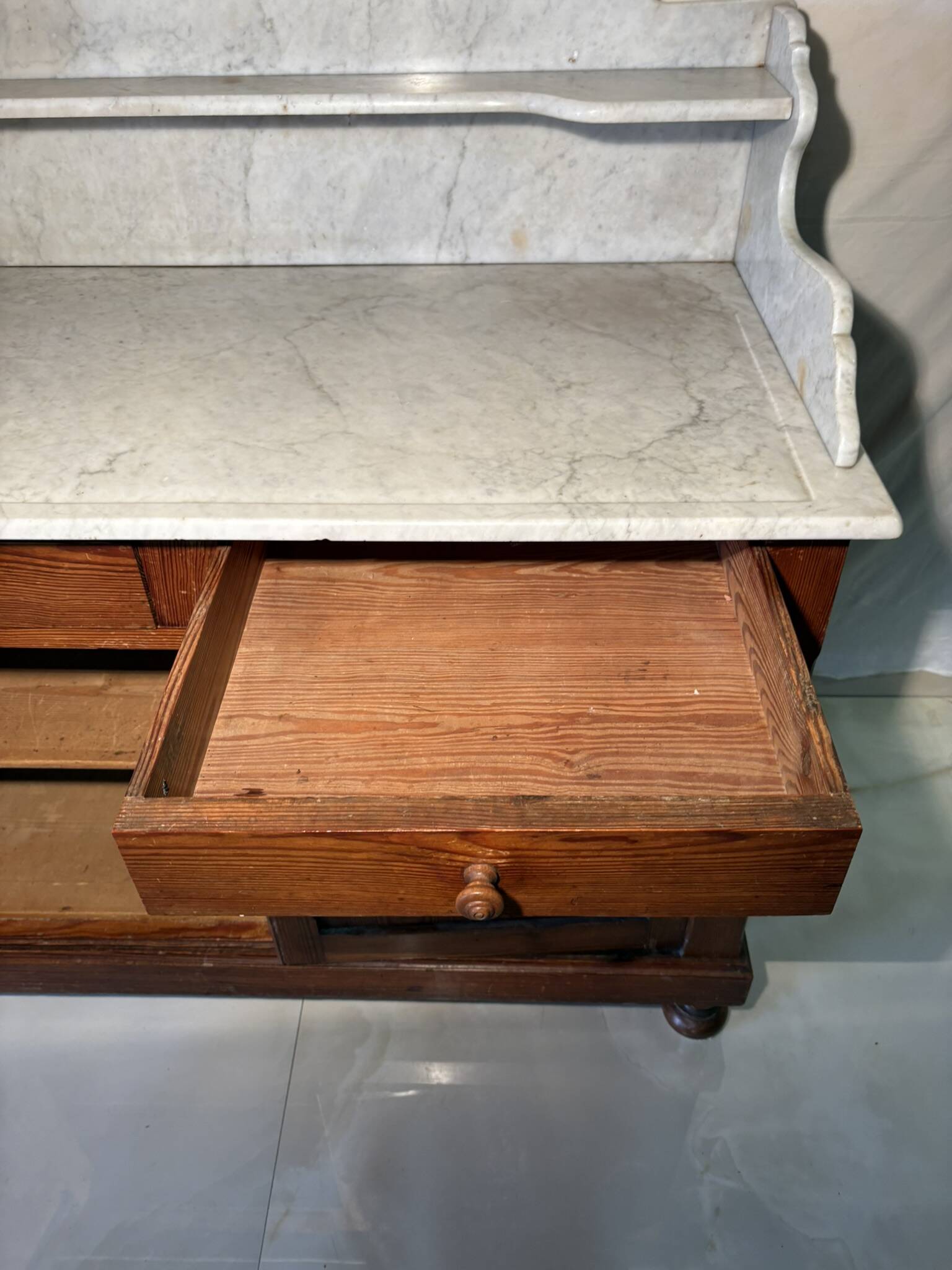 Antique wood and marble kitchen sideboard with carved backsplash