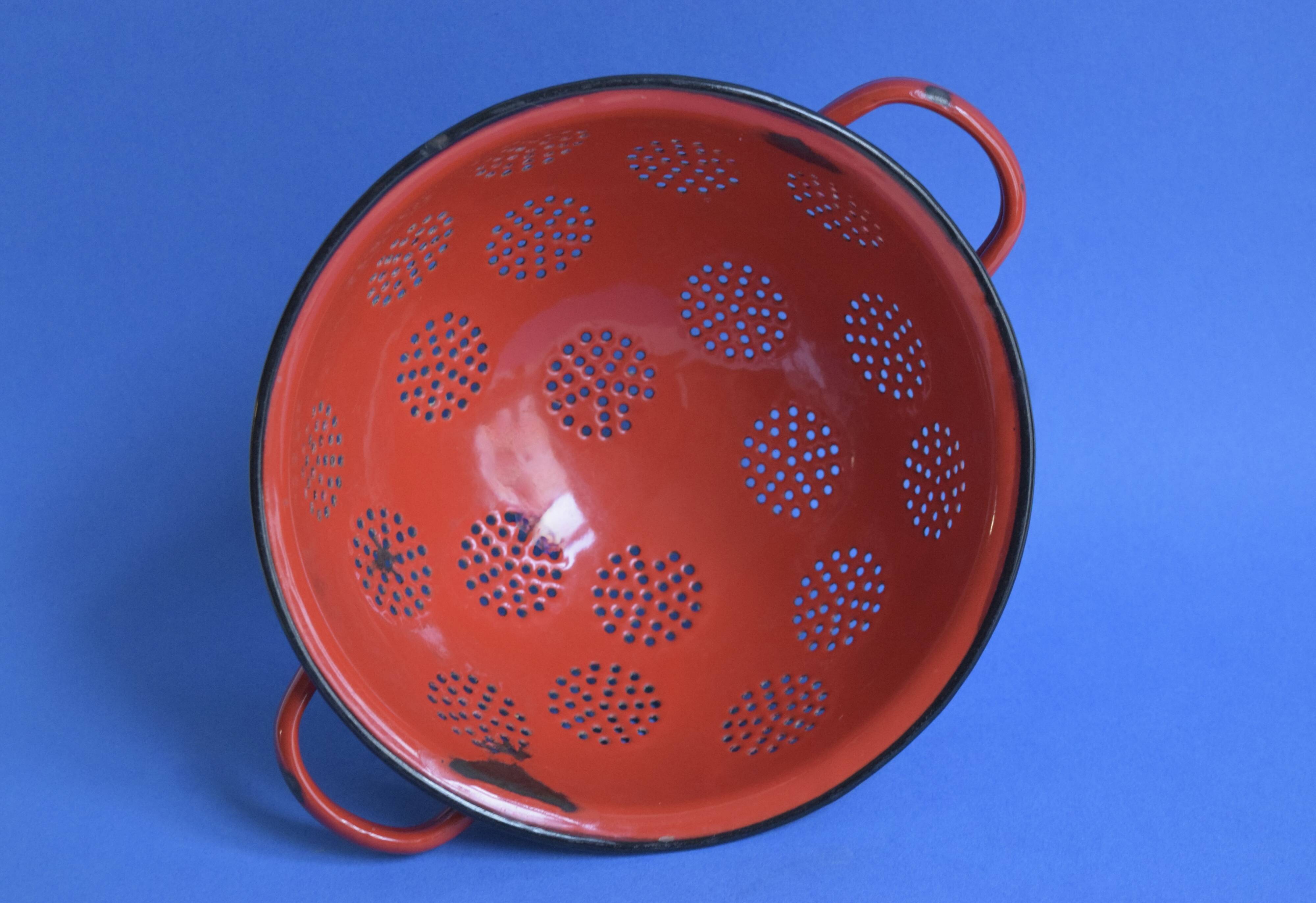 Vintage red enameled sheet metal colander