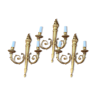 Set of three Empire-style candlesticks.
