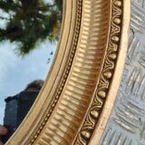 Antique oval mirror in gilded stucco with gold leaf, 19th century